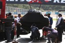 Rubens Barrichello's Williams is returned to the pits after he stopped on track 