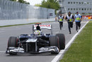 Marshals run to move Pastor Maldonado's Williams after he hit the 'Wall of Champions'