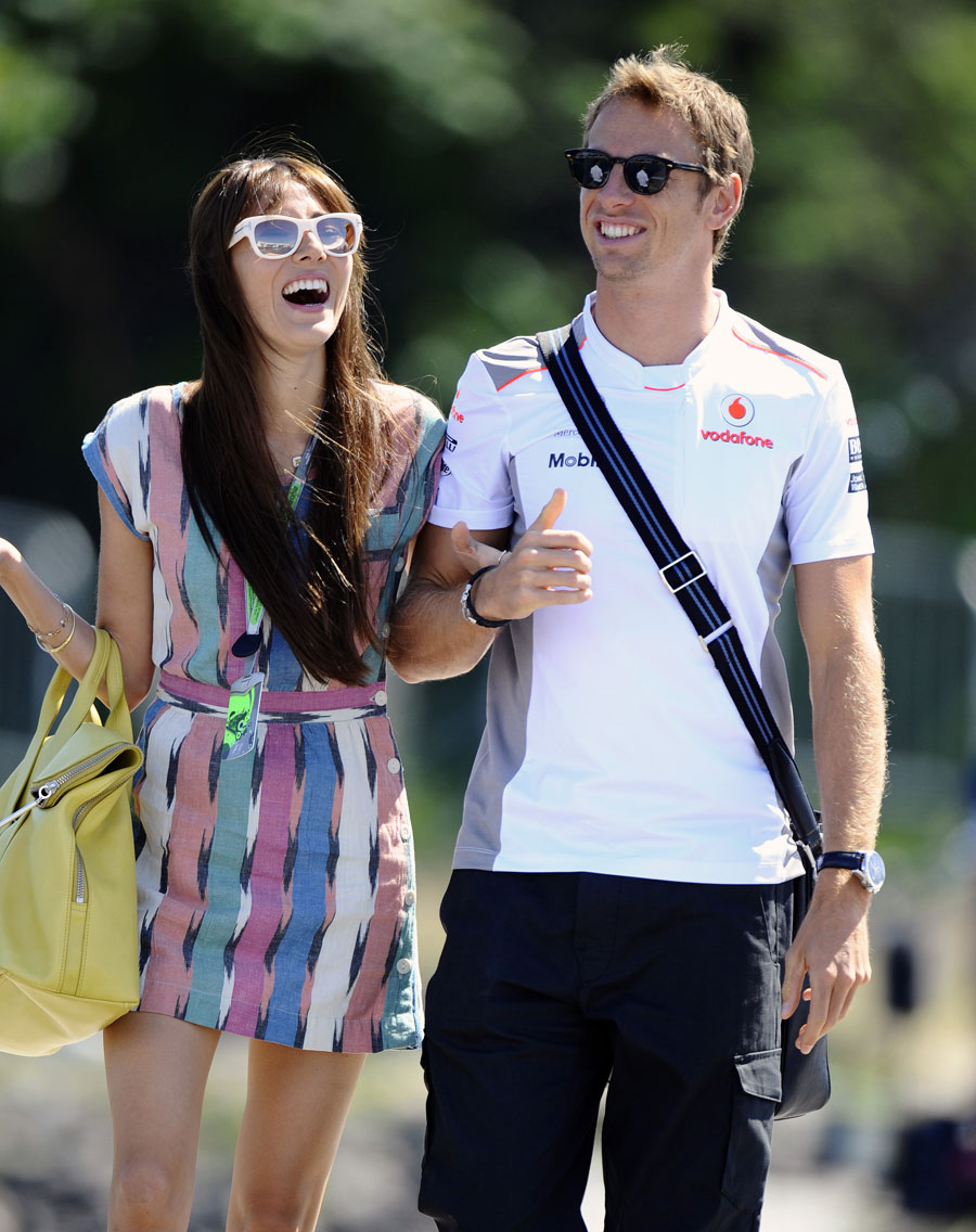 Jenson Button arrives in the paddock with girlfriend Jessica Michibata