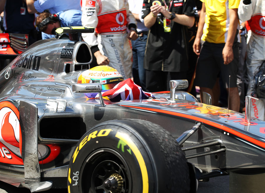 Lewis Hamilton celebrates his victory as he returns to the pits