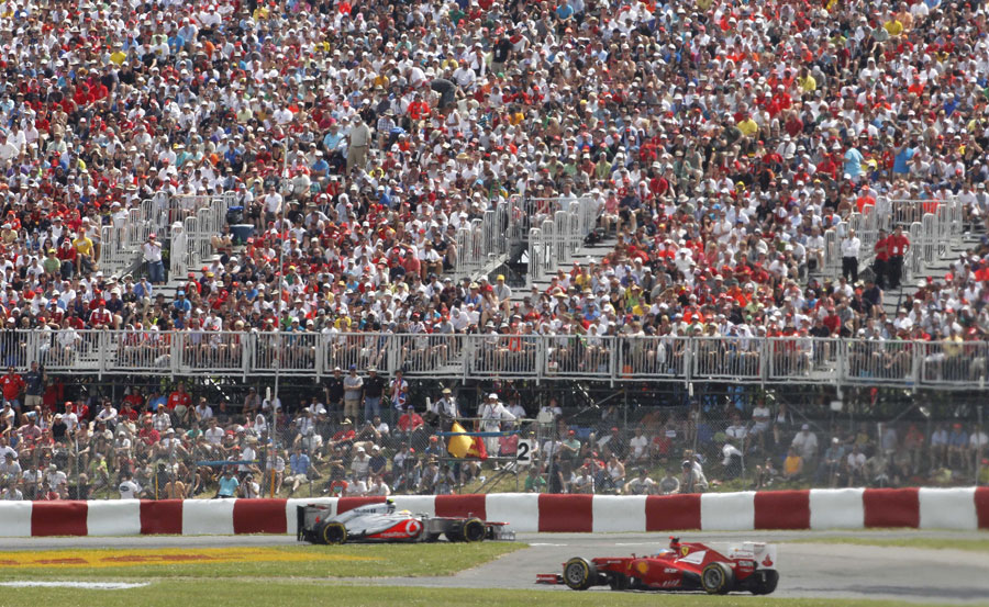 Lewis Hamilton and Fernando Alonso tackle the opening sector in front of a large crowd