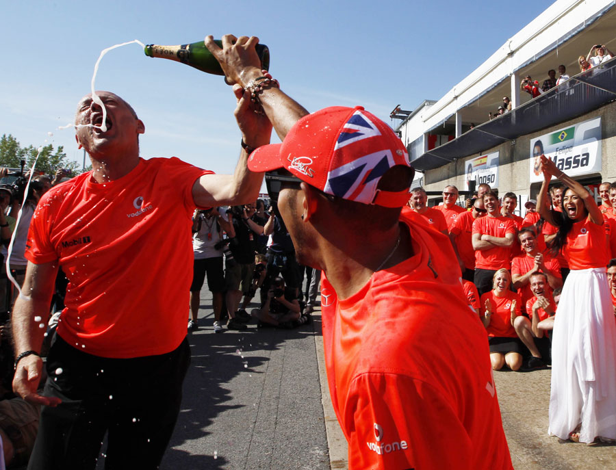 Lewis Hamilton celebrates his victory with McLaren chairman Ron Dennis