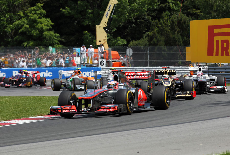 Jenson Button leads a train of cars early in the race