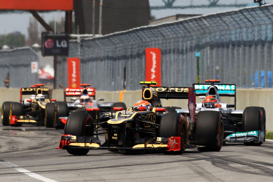 Romain Grosjean leads a pack of cars into the final chicane