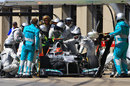 Mercedes mechanics work on Michael Schumacher's broken DRS