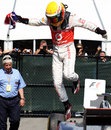 Lewis Hamilton jumps from his car in parc ferme