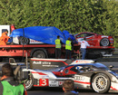 Anthony Davidson's Toyota and the Ferrari 458 Italia are tended to after crashing at Le Mans 
