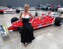 A glamour model poses with Gilles Villeneuve's 312T- 5 Ferrari at the Formula One Expo in Austin
