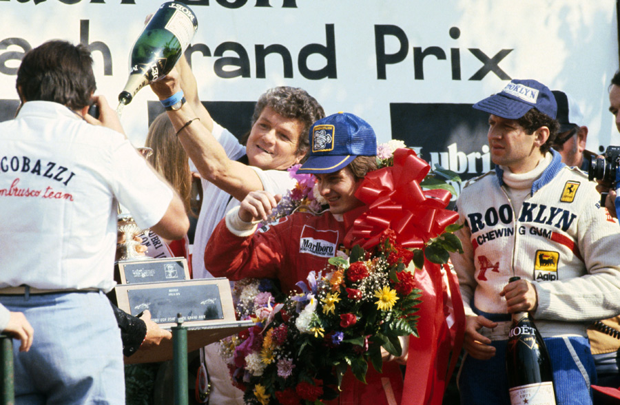 Gilles Villeneuve vcelebrates his win on the podium with second placed team mate Jody Scheckter 