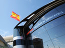 A Spanish flag flies above the McLaren motorhome