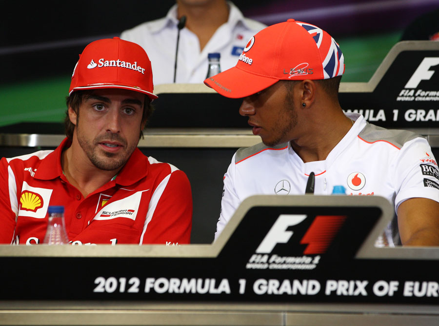 Fernando Alonso and Lewis Hamilton chat during the driver press conference