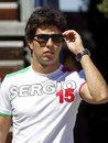 Sergio Perez walks through the paddock on Thursday