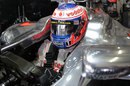 Jenson Button waits in his car in the McLaren garage