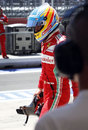 Fernando Alonso walks back after being eliminated in Q2