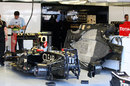 Romain Grosjean's car and a spare floor in the Lotus garage