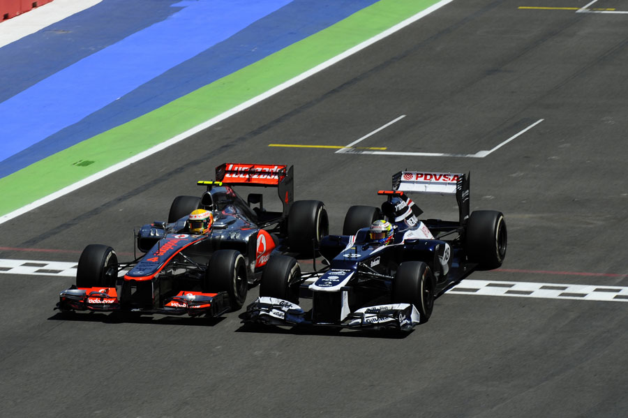 Lewis Hamilton and Pastor Maldonado go wheel to wheel