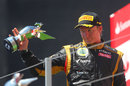 Kimi Raikkonen with his trophy on the podium