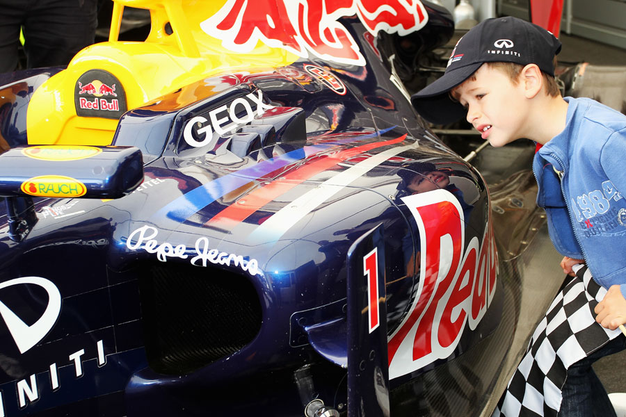 A young boy gets a close-up view of a Red Bull at the Festival of Speed