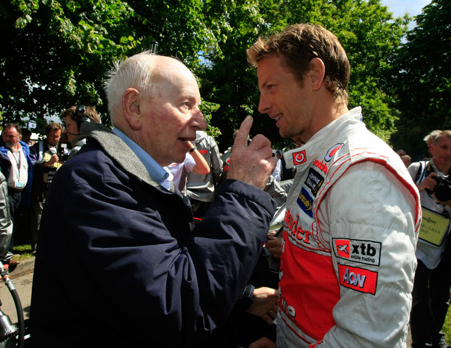 Former champions Jenson Button and John Surtees chat at the Festival of Speed