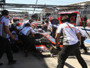 Jenson Button makes a pit stop during final practice