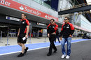Timo Glock walks the track with his engineers on Thursday