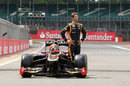 Romain Grosjean poses on the starting grid with his Lotus E20