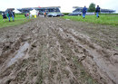 Fans avoid the mud in a closed car park at Silverstone on Saturday morning
