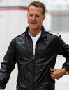 Michael Schumacher walks through the paddock