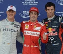 Michael Schumacher, Fernando Alonso and Mark Webber celebrate taking the top three places on the grid