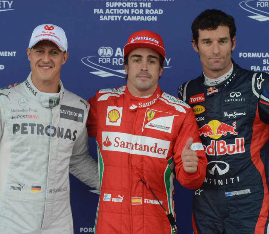 Michael Schumacher, Fernando Alonso and Mark Webber celebrate taking the top three places on the grid