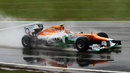 Nico Hulkenberg throws up a plume of spray in Q1