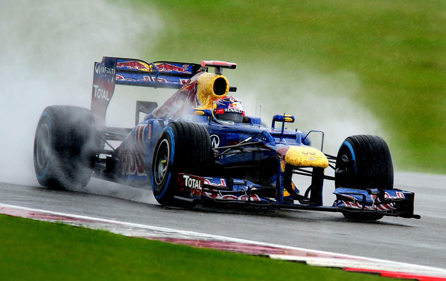 Sebastian Vettel looks for grip on the wet tyres
