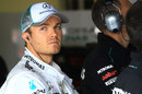Nico Rosberg watches on from the garage during a rain delay