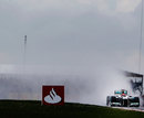 Michael Schumacher picks a route through the spray