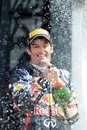 Mark Webber celebrates his victory on the podium