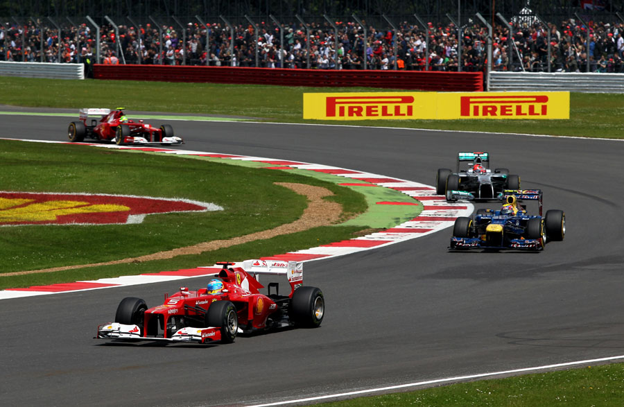 Fernando Alonso leads Mark Webber and Michael Schumacher early in the race