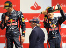 Sebastian Vettel pours champagne on Sir Jackie Stewart on the podium