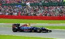 Mark Webber passes a packed grandstand