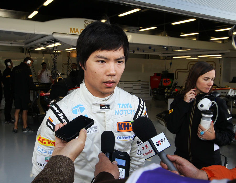 Ma Qing Hua talks to the press outside the HRT garage