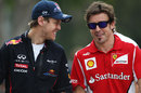 Sebastian Vettel and Fernando Alonso share a joke in the paddock