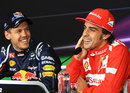 Sebastian Vettel and Fernando Alonso share a joke in the post-qualifying press conference