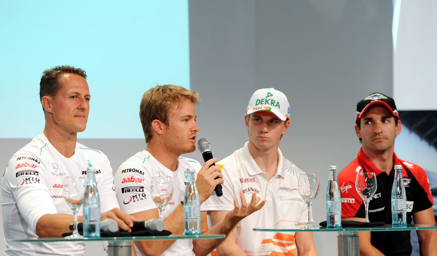 Nico Rosberg answers a question alongside his fellow German drivers during a FOTA Fans Forum
