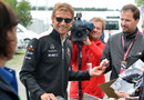 Jenson Button in relaxed mood as he signs autographs for the fans