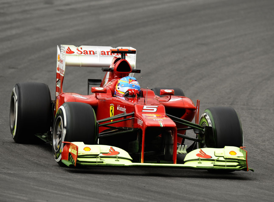 Fernando Alonso's Ferrari on track on medium tyres