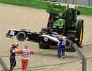 Valtteri Bottas is led away from the scene of his accident