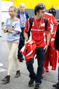 Fernando Alonso arrives in the paddock with his girlfriend Dasha Kapustina