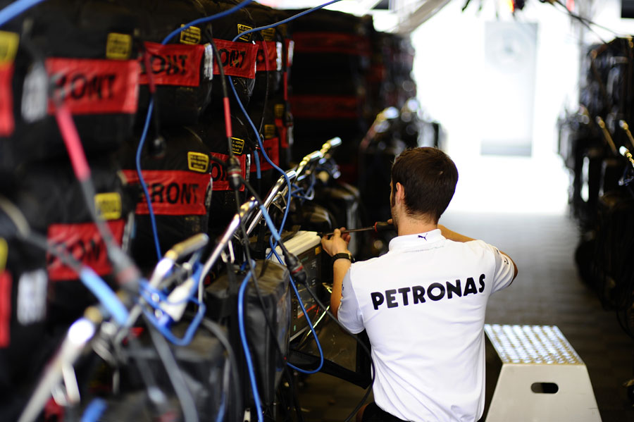 A Mercedes mechanic works on the team's allocation of tyres on Saturday morning
