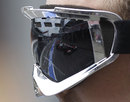 Lewis Hamilton is reflected in a McLaren engineer's visor