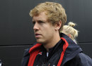 Sebastian Vettel walks through the paddock on Sunday morning