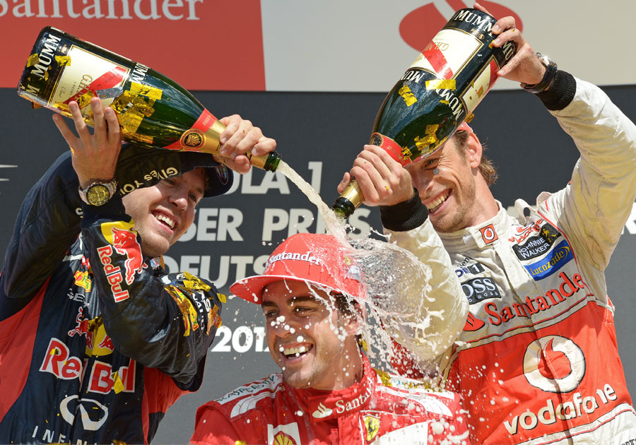 Sebastian Vettel and Jenson Button celebrate with Fernando Alonso 